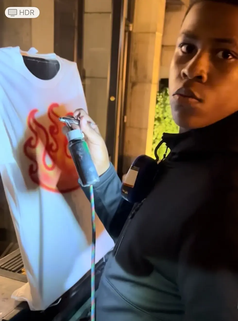 Artist creating a colorful flame design at the Target event