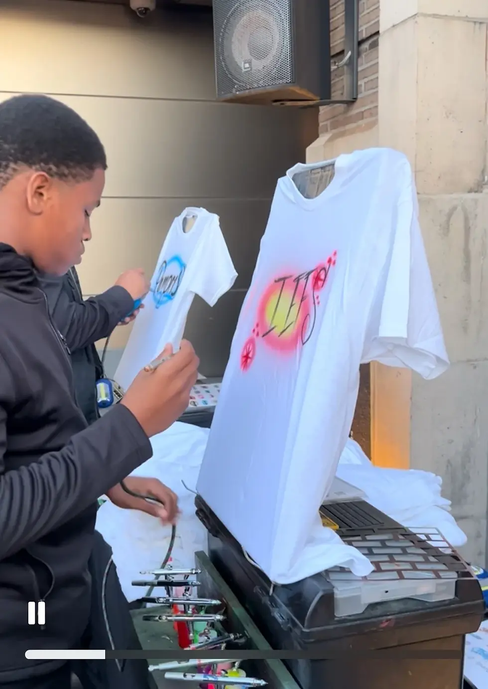 Airbrush artists customizing white T-shirts at the Target event in Philadelphia