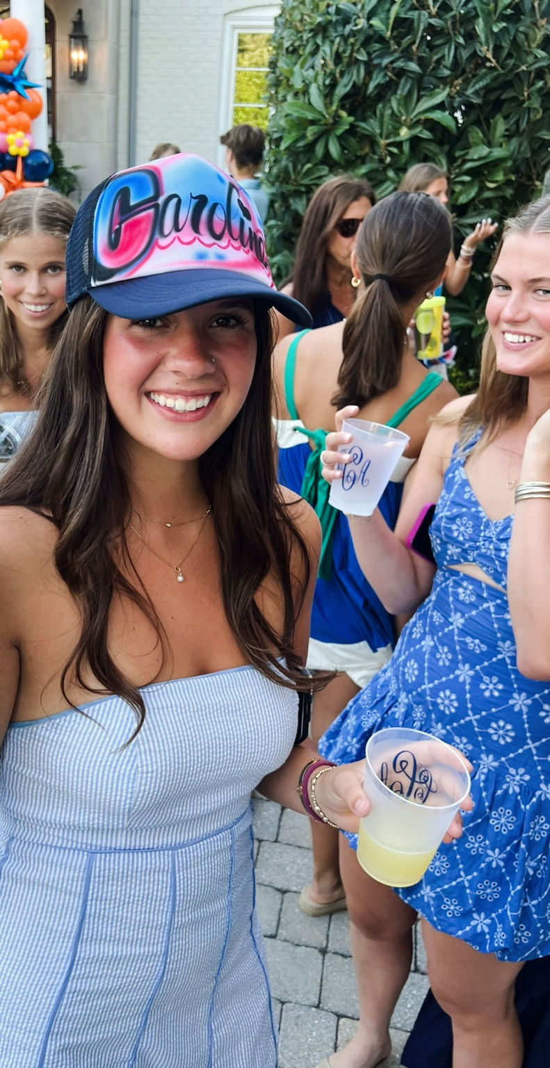 Guest wearing a colorful Grace airbrushed trucker hat at a Virginia Beach graduation party