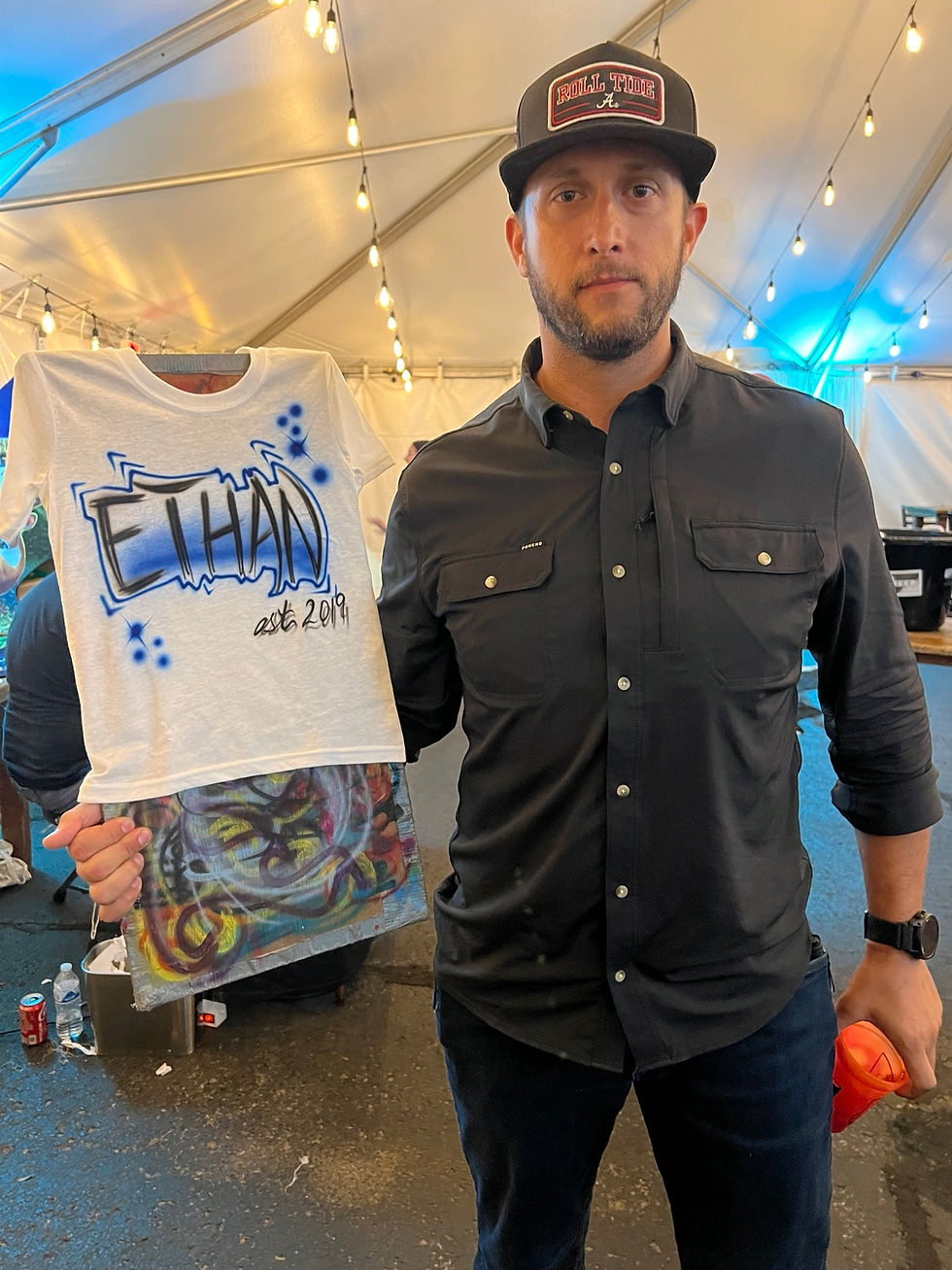 Backstage guest displaying a custom Ethan airbrushed shirt