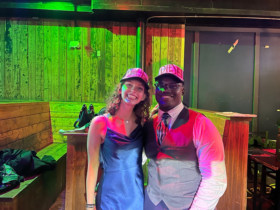 Two University of South Carolina event guests wearing custom airbrushed hats
