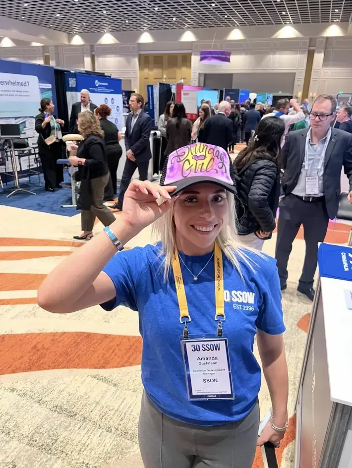 Conference guest wearing a pink and yellow personalized airbrushed hat
