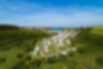 Aerial view of a large campsite near a beach town