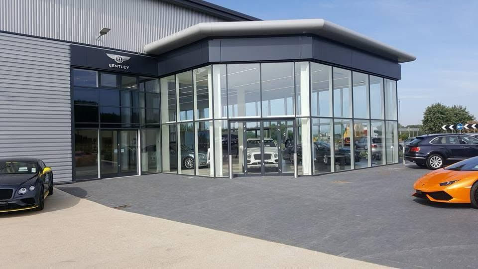 Modern Bentley car dealership showroom with luxury cars outside