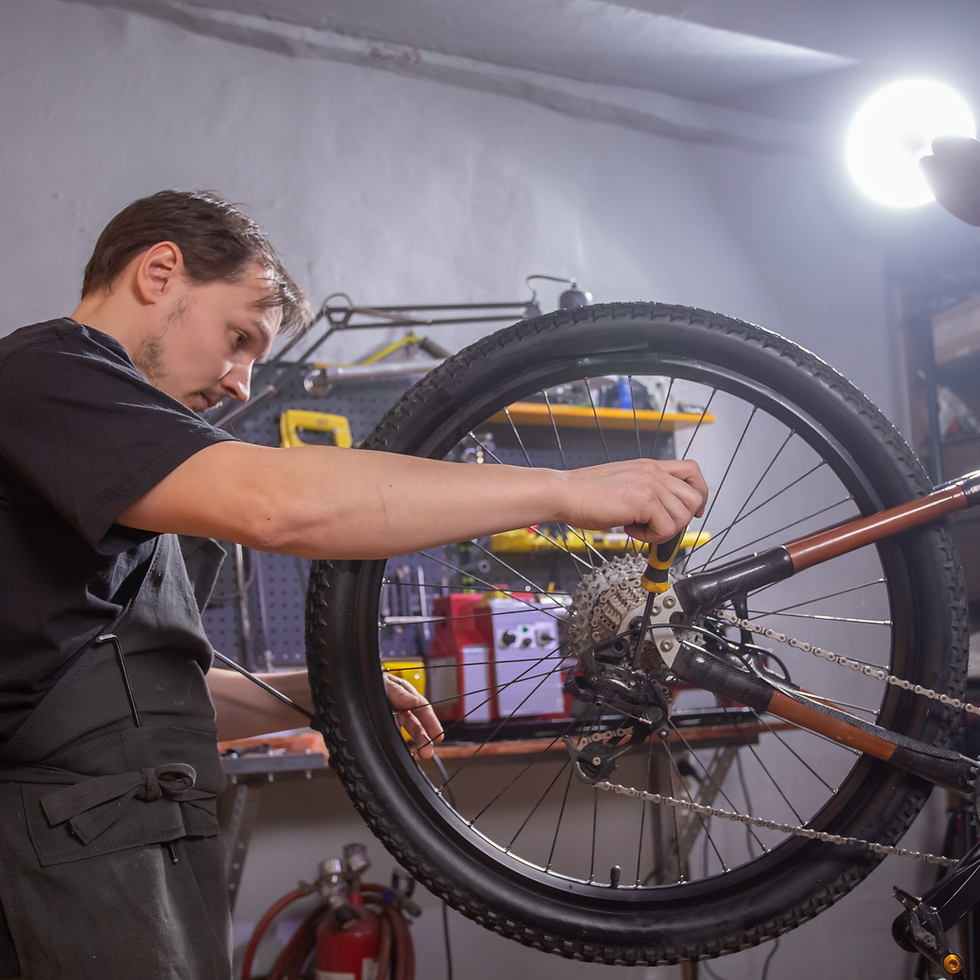 Man repairing bicycle rear wheel