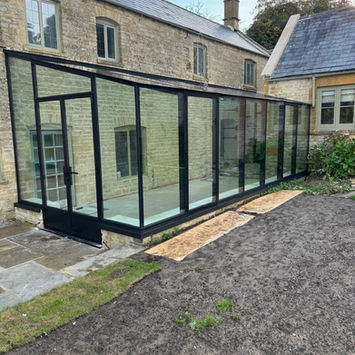 New glass conservatory on a stone house