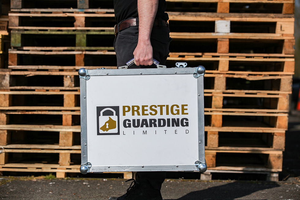 Person holding a case with Prestige Guarding Limited logo