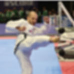 Man in white dobok performing a kick