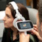 Woman gets ear examined with device displaying ear canal on screen