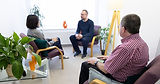 Three people in a discussion session