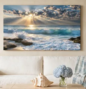 Large gallery-wrapped ocean sunrise canvas displayed above a cream sofa on a warm neutral living room wall, illustrating how to hang large canvas wall art without damaging the wall.