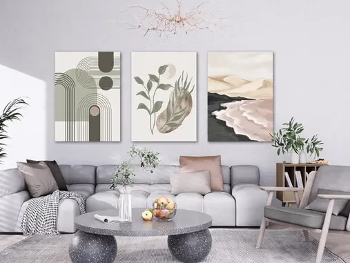 Three coordinated canvas wall art styles—a geometric abstract, minimalist botanical and neutral landscape—displayed cohesively above a gray sectional in a modern living room.