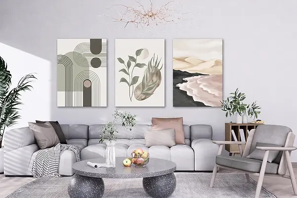 Eclectic living room gallery wall mixing gallery-wrapped abstract, minimalist, botanical and coastal canvas art in varied sizes unified by a coordinated color palette.