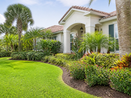 Beautiful Florida Late-Summer Landscape Maintenance including lush green lawn, bushes, mulch and colorful trees.