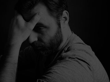 Man in emotional reflection. shadow cast behind him, symbolizing inner conflict and betrayal trauma.