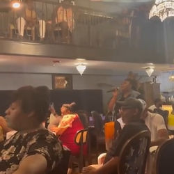 Sasha Mobley singing among a crowd