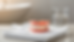 Close-up view of a denture resting beside a soft cleaning brush and water glass.