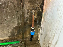 Pipes and valves against wall