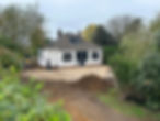 House under construction with machinery