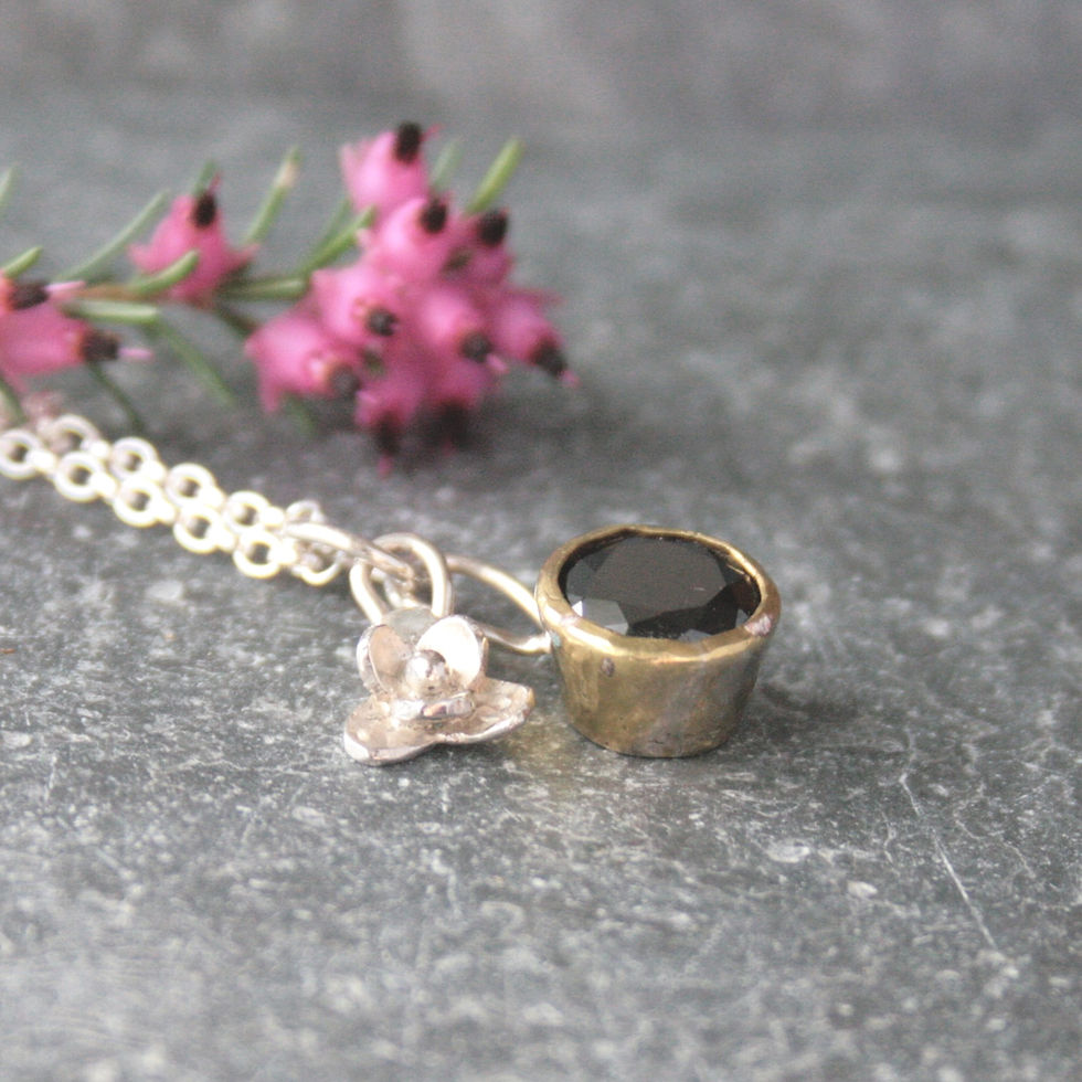 Thumbnail: Dainty silver charm necklace with silver flower and black cubic zirconia