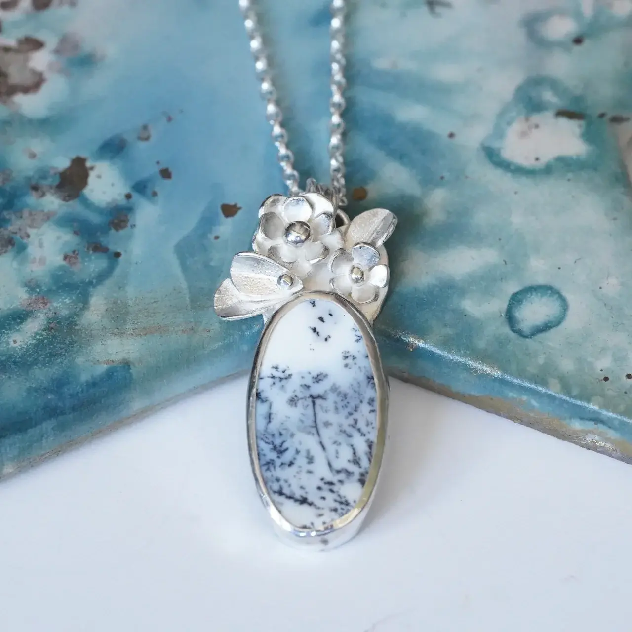 Dendritic opal gemstone necklace with silver flowers