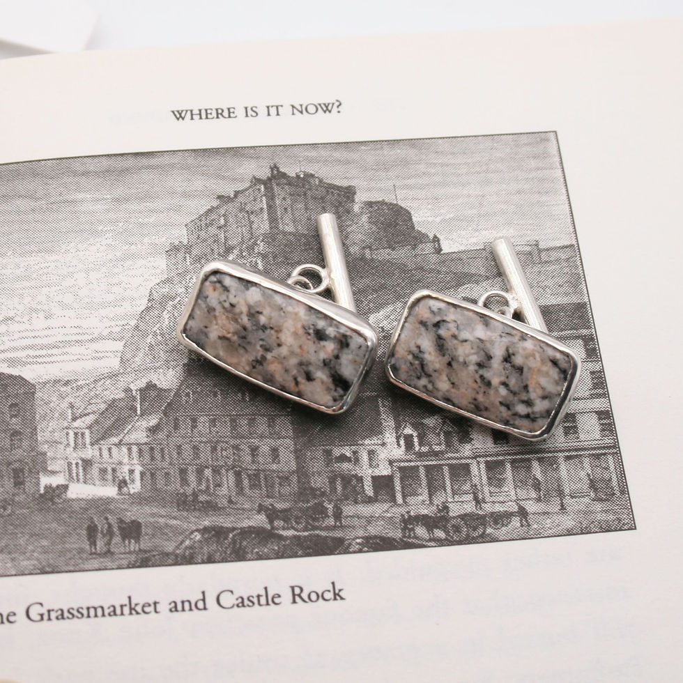 Thumbnail: Edinburgh Royal Mile cobblestone cufflinks lying on a black and white image of Edinburgh