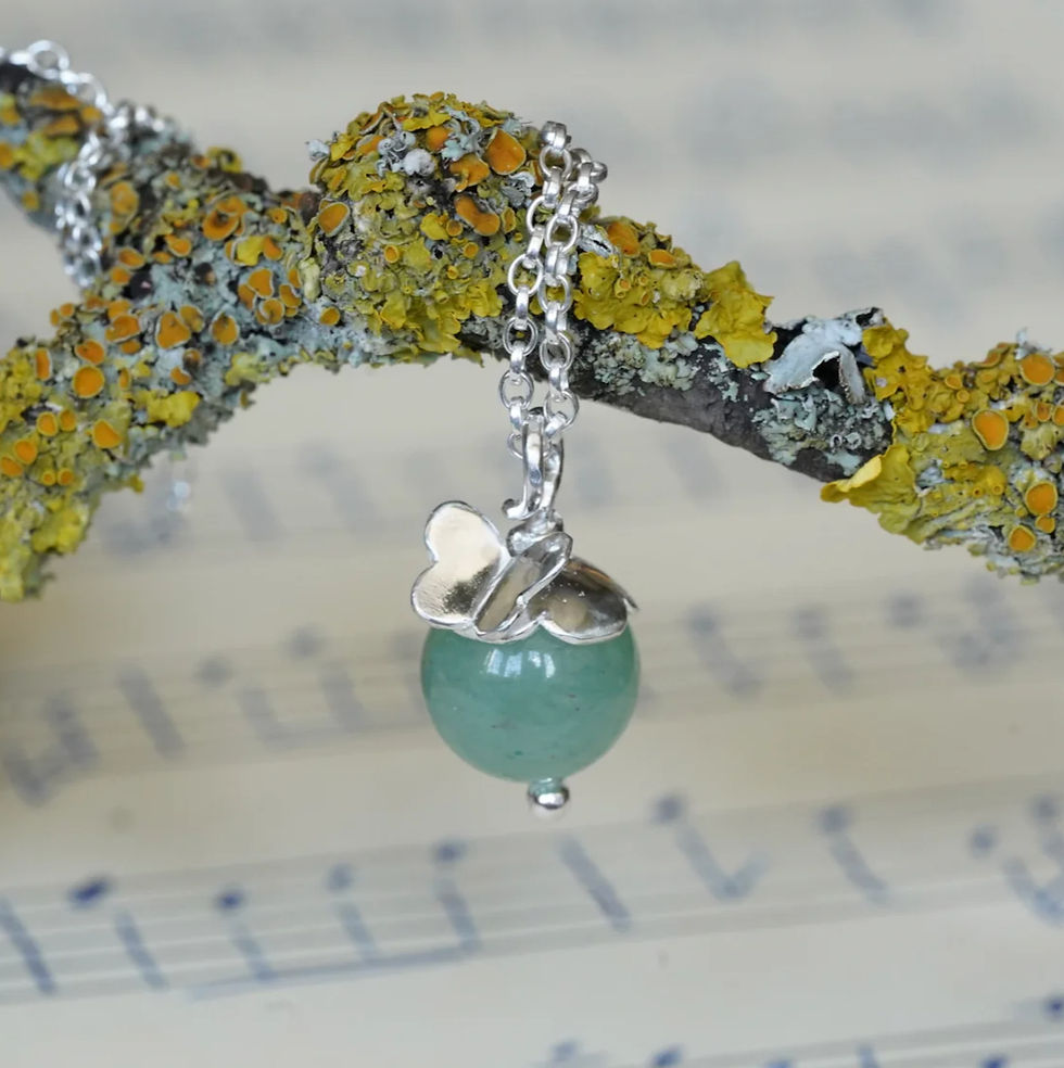 Aventurine and butterfly necklace hanging from lichen twig