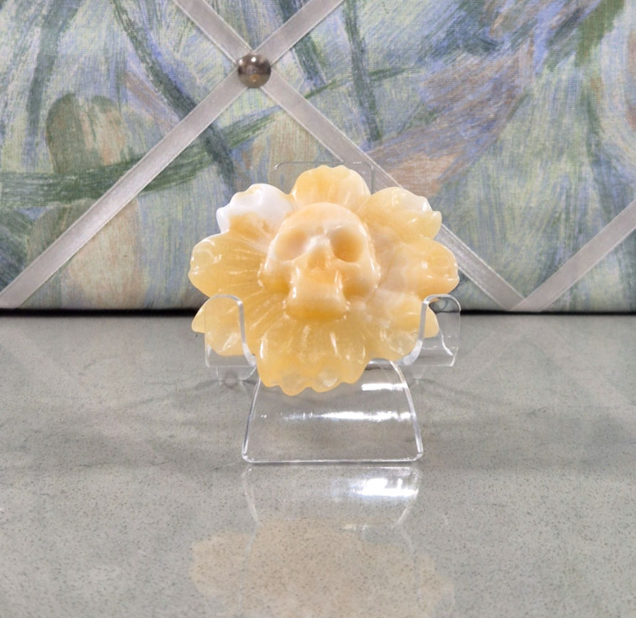 Yellow calcite flower carving with skull in the centre