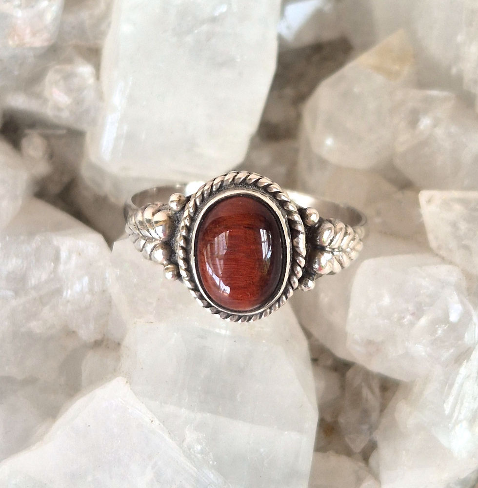 Tigers eye antique style silver ring with leaf motifs nestled into an apophyllite crystal cluster