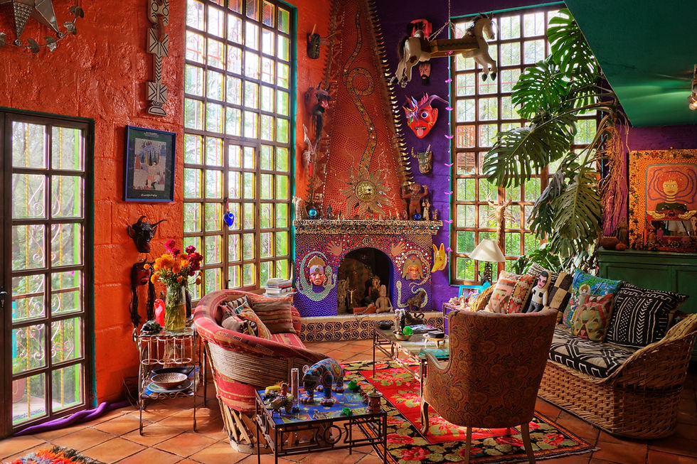 Colorful eclectic interior with vibrant walls, masks, and mosaic fireplace