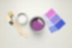 Interior paint selection with brushes, open paint can, and color swatches — choosing the right interior paint shade.