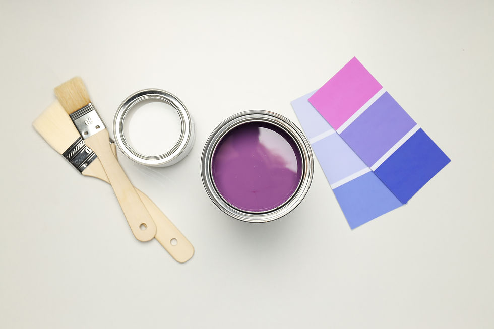 Interior paint selection with brushes, open paint can, and color swatches — choosing the right interior paint shade.