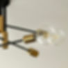 Close-up of a gold-and-black ceiling light fixture — electrical installation in a renovated property