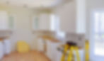 White kitchen cabinet installation in progress.