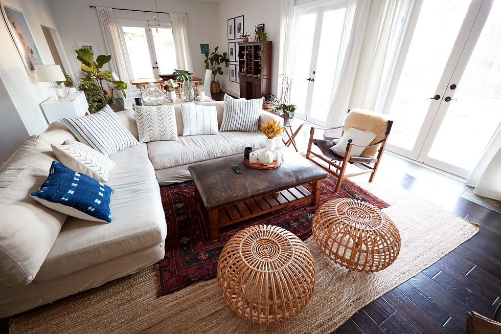 Bohemian-style living room with eclectic decor, rattan stools, and indoor plants