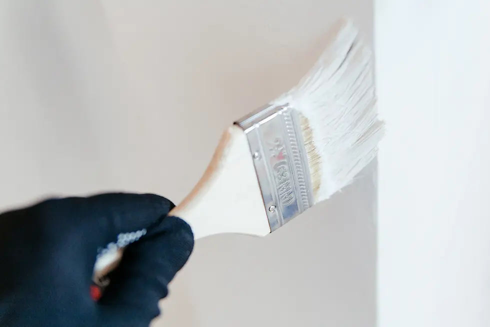 Close-up of interior wall painting with brush — clean lines and professional finish