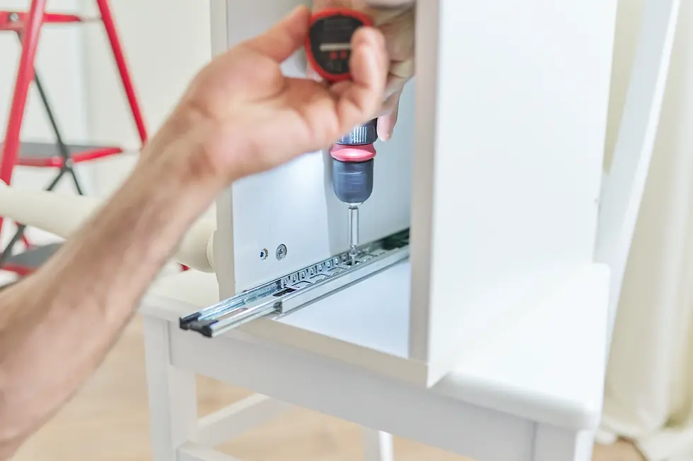 Handyman assembling IKEA furniture with power drill — secure and precise assembly service