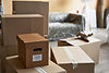 Room filled with professional moving boxes and packing materials for expert long-distance packing services