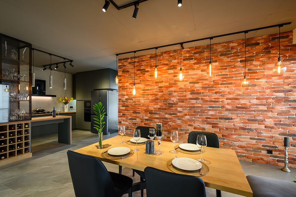 Industrial-style kitchen with exposed brick wall and Edison bulbs