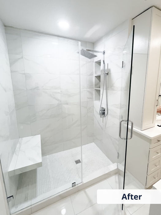 Modern shower with large format white marble tile and glass door