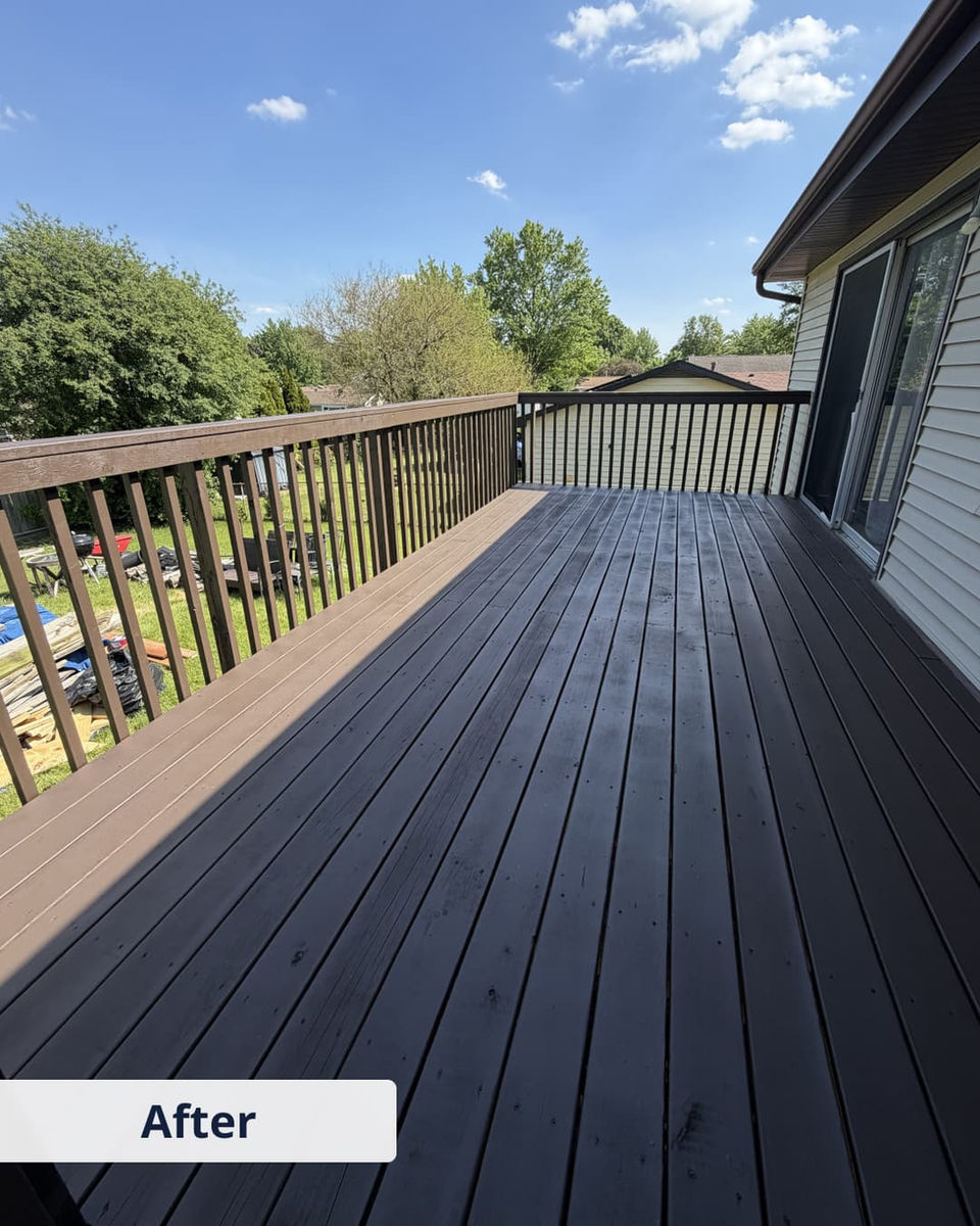 Restored deck with new dark boards and repaired railings