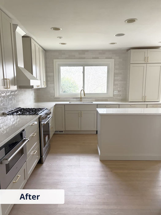 Finished kitchen with white cabinets, countertops, island, and new flooring