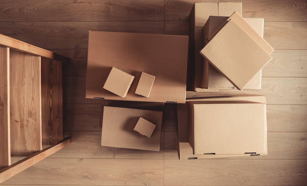 Overhead view of packed cardboard boxes and a step ladder, symbolizing preparation to lower local moving costs