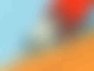 Hand in a red glove applying caulk along a joint with a caulking gun, holding the nozzle at an angle.