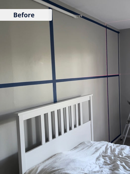 Before photo showing taped wall layout in bedroom, preparing for custom painted accent wall