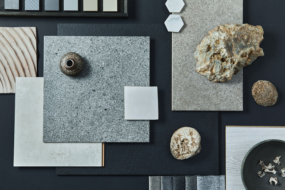 Flat lay of textured materials including stone, tile, wood, and fabric swatches — illustrating texture contrast in interior design.