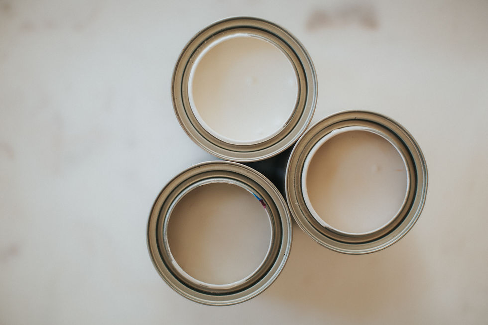 Three open cans of paint primer viewed from above — illustrating the article on best paint primers for drywall, wood, and stain-blocking surfaces.