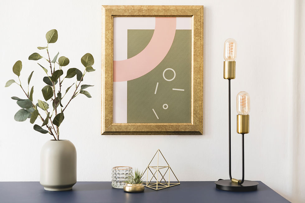 Modern tabletop decor arrangement with geometric forms and artwork — illustrating proportional balance and golden ratio principles in interior styling.