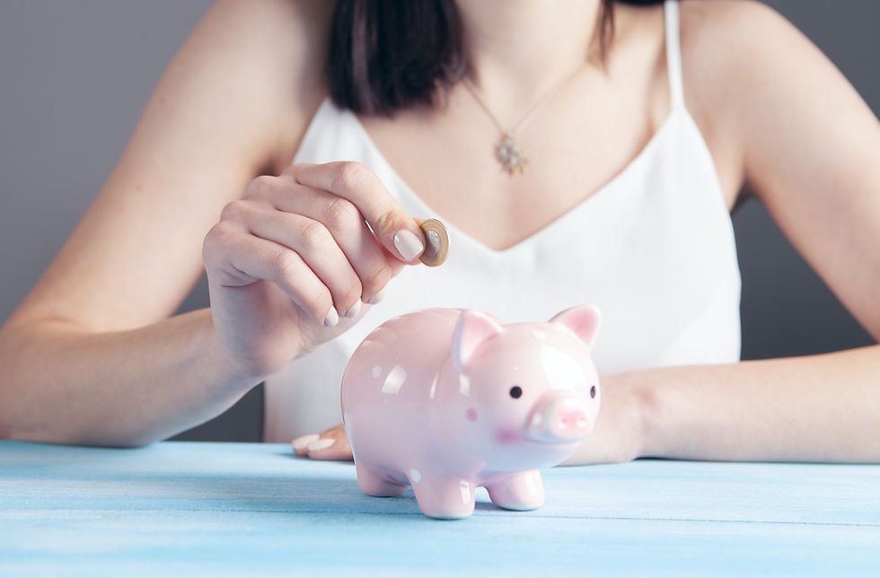 Person putting a coin into a pink piggy bank, representing strategies to save money on an interstate move