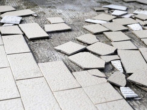 broken floor tiles ready for disposal
